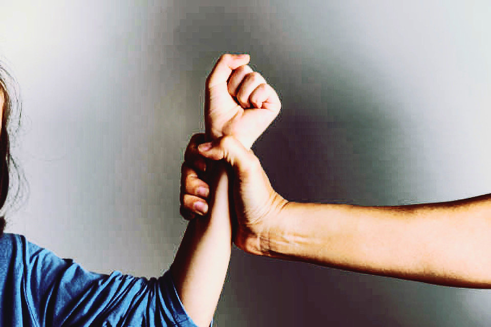 Parent is holding her little girls arm and is about to use violence. Representing child abuse and domestic violence.
